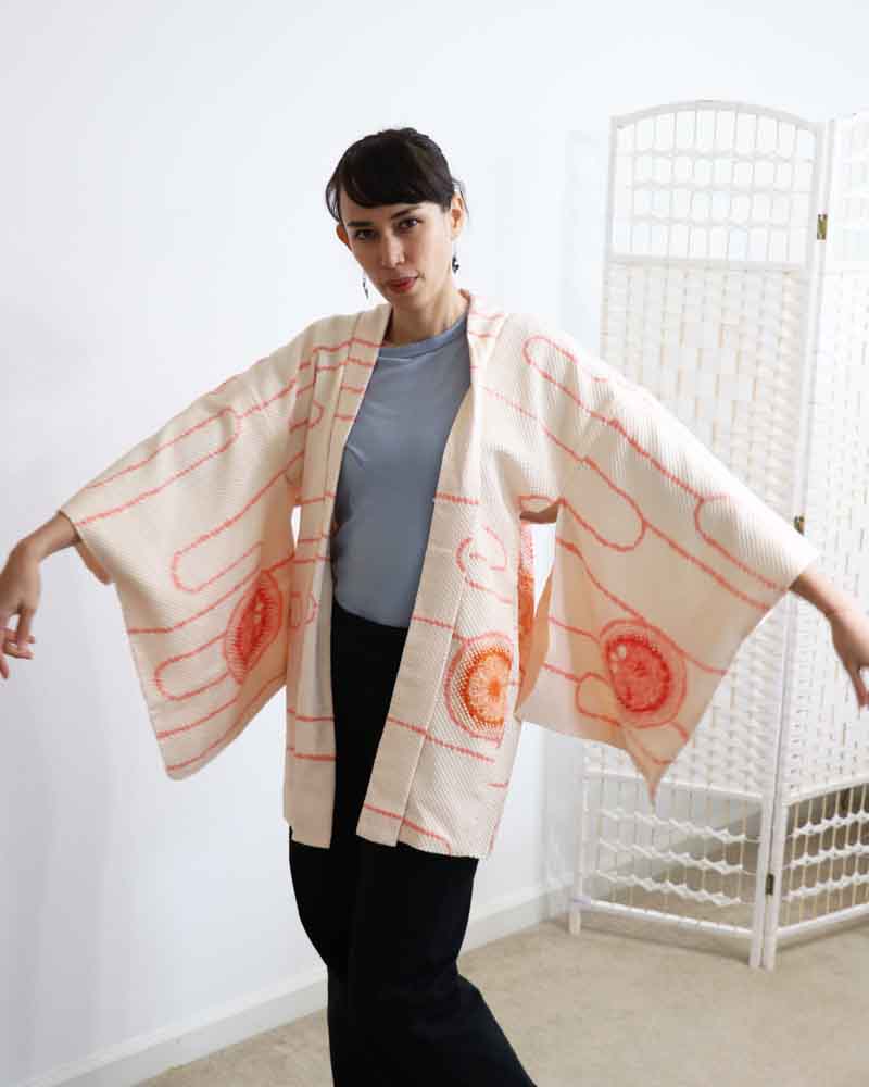 A woman wearing a Powder Pink kimono, facing forward.