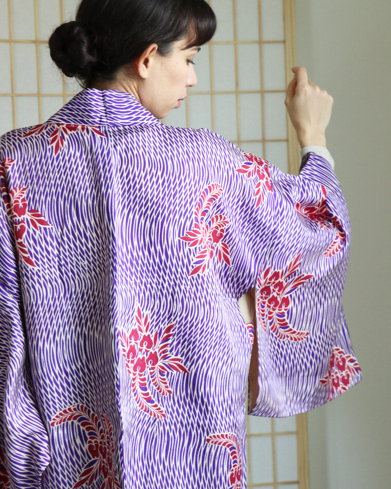 Haori Jacket of the KIMONO ZEN brand in shades of  Purple, white and red wisteria patterns, back view of a woman wearing a Kimono Jacket, upper body