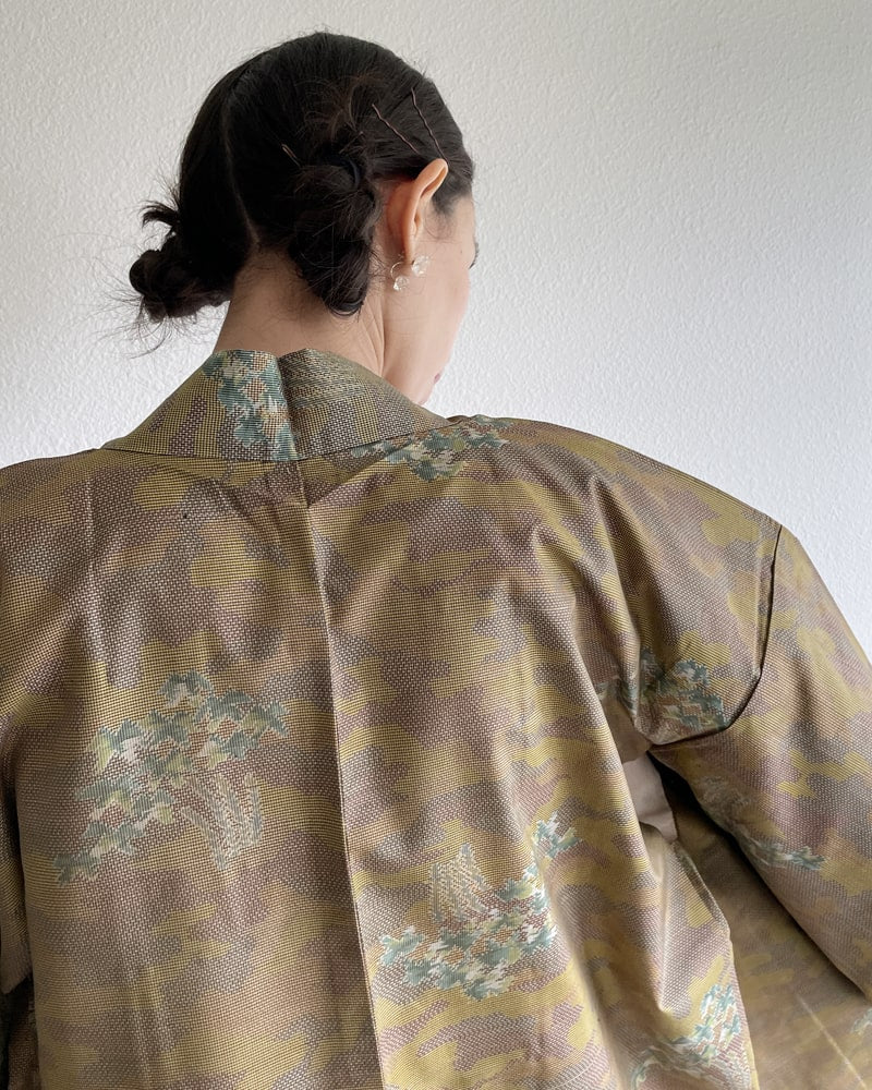Bamboo Yellow Brown Oshima Tsumugi Haori Kimono Jacket by KIMONO ZEN brand, back side of a woman wearing ochre color with an ivory colored dress made of natural material.