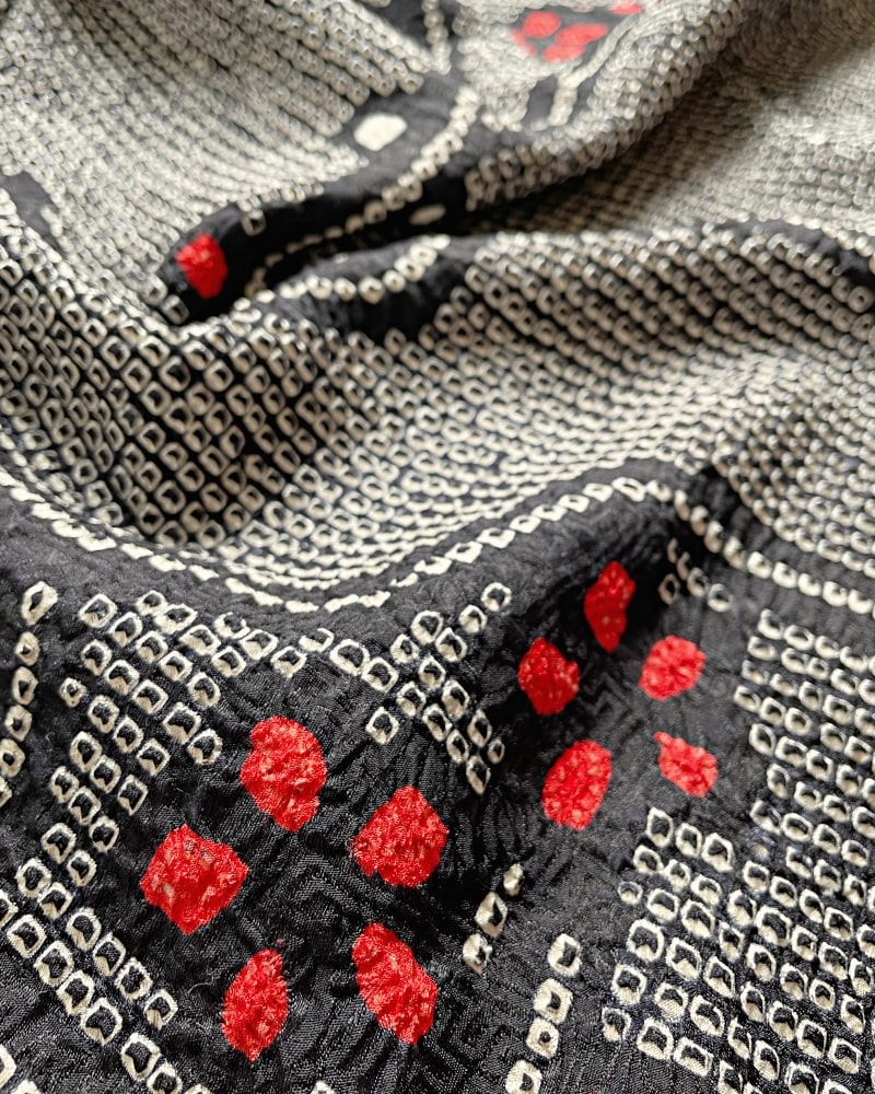 Enlarged image of a Kimono zen brand Black Cherry Blossom Shibori Haori Kimono Jacket with a bright red plum pattern on a black shibori fabric.