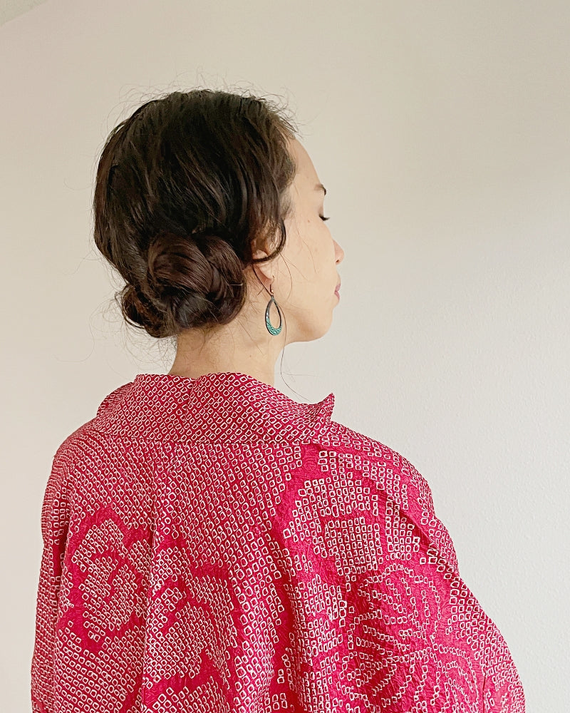 Woman in kimono haori of red-colored shibori fabric