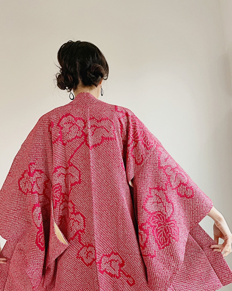 Woman in kimono haori of red-colored shibori fabric