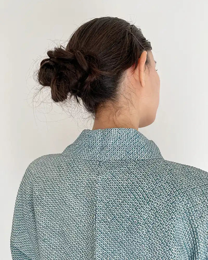 Woman wearing light blue butterfly-patterned kimono haori jacket with white T-shirt and jeans