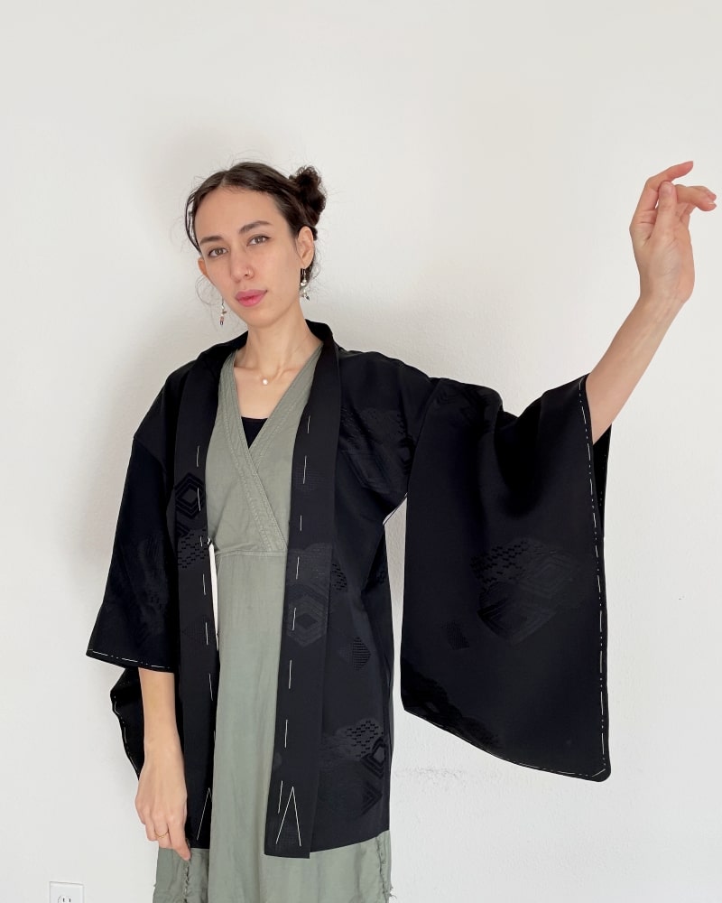 Black Rhombic Haori Kimono Jacket of Kimono zen brand, black fabric, upper body of a woman wearing a green dress with