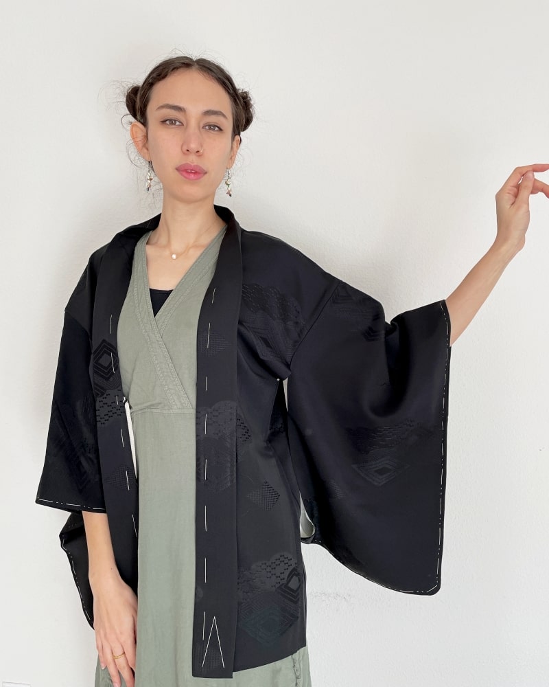 Black Rhombic Haori Kimono Jacket of Kimono zen brand, black fabric, upper body of a woman wearing a green dress with