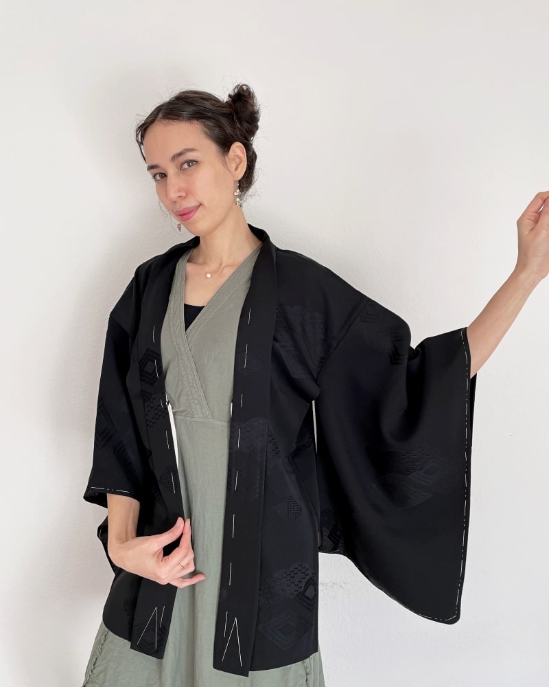 Black Rhombic Haori Kimono Jacket of Kimono zen brand, black fabric, upper body of a woman wearing a green dress with