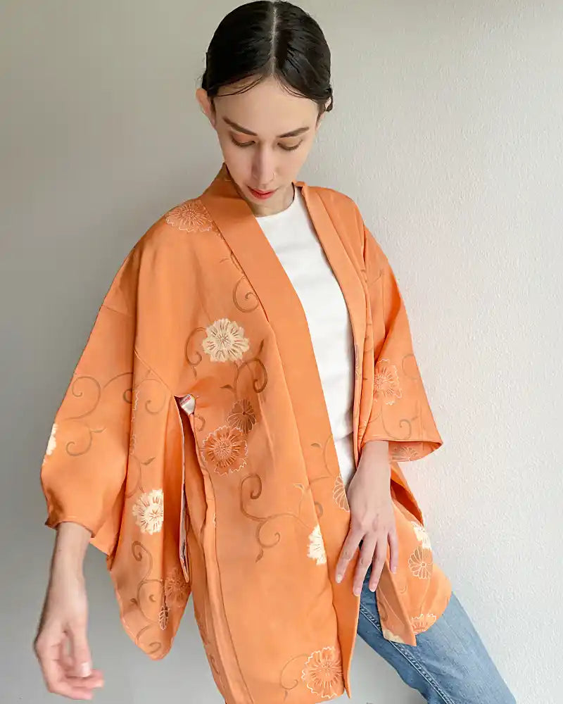 Woman wearing coral colored haori.