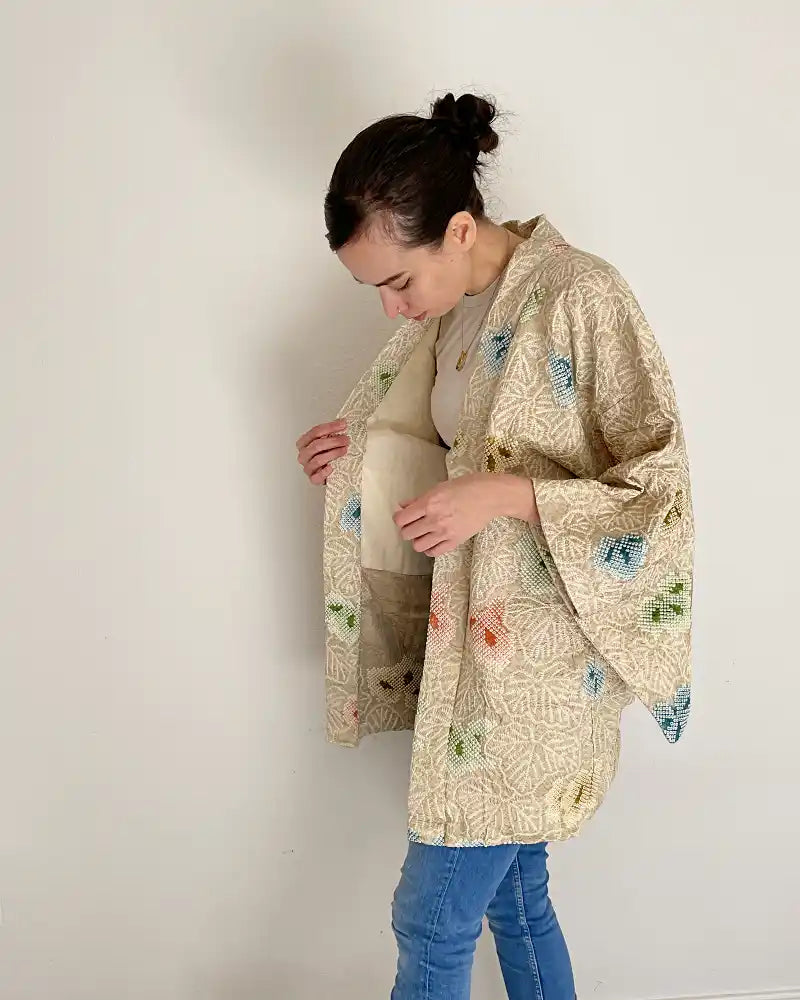 Woman looking the lining of the kimono jacket.